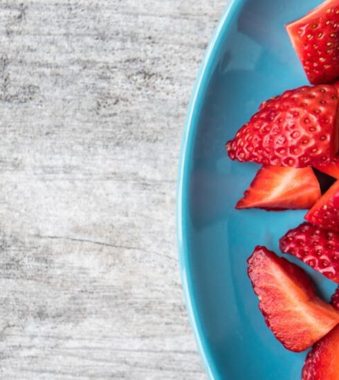 Diet - sliced strawberries on teal ceramic plate