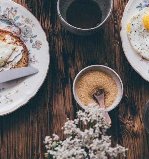 Meals - Breakfast Meals beside a Cup of Coffee on a Wooden Table