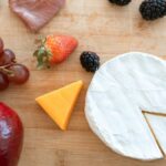 Healthy Eating - Sliced Cheese and Strawberries on Brown Wooden Chopping Board