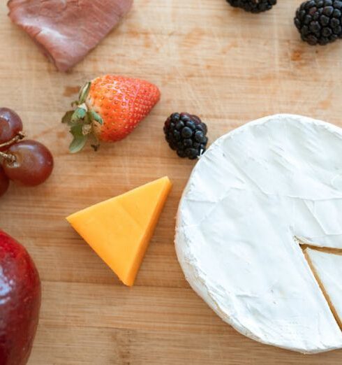 Healthy Eating - Sliced Cheese and Strawberries on Brown Wooden Chopping Board