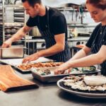 Cooking - Man and Woman Wearing Black and White Striped Aprons Cooking