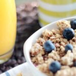 Muesli - Bowl of Oatmeal With Berries Beside Glass of Juice