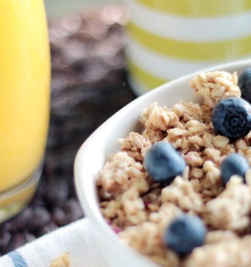 Muesli - Bowl of Oatmeal With Berries Beside Glass of Juice