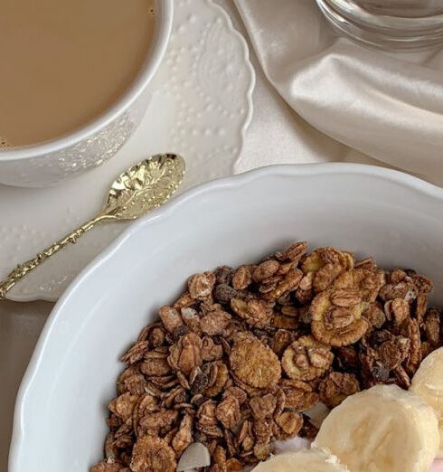 Muesli - Bowl of Cereals Beside a Cup of Hot Chocolate