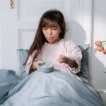 Muesli - Woman eating breakfast in a bed