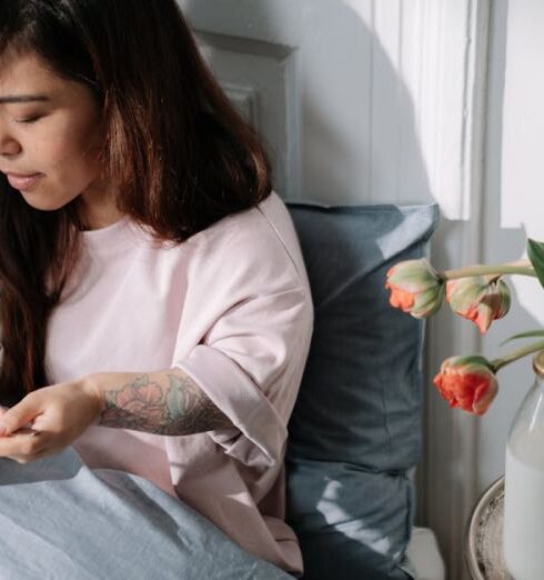 Muesli - Woman eating cereal with milk sitting in a bed