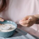 Muesli - Woman eating cereal with milk