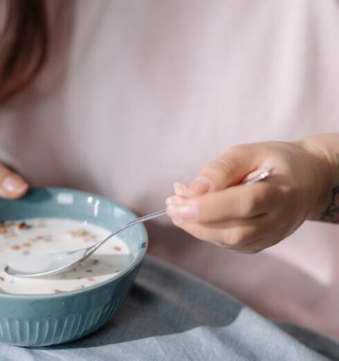 Muesli - Woman eating cereal with milk