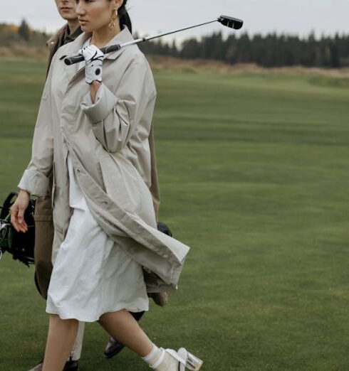 Tee - Woman in White Coat Holding Black Dslr Camera on Green Grass Field