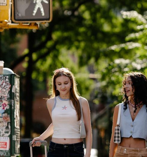 Crop Tops - Young Girls Walking in City with a Suitcase