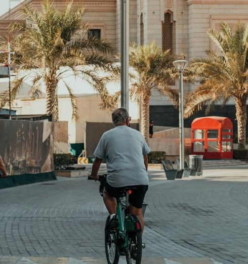 Joggers - Morning waterfront promenade with palm trees and cyclists on modern marina walkway