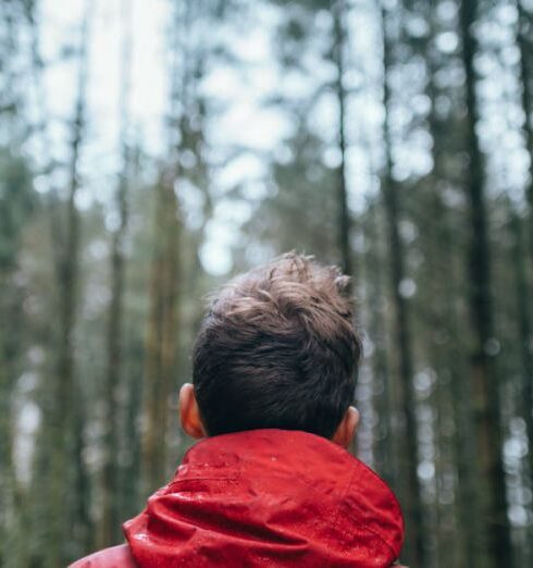 Jacket - Shallow Focus Photo of Man Wearing Black and Red Jacket Standing in Forest