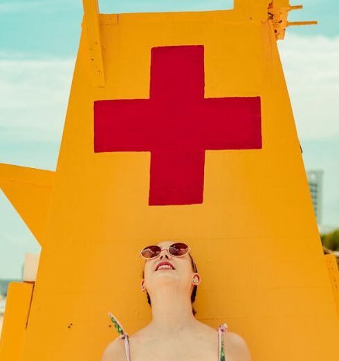 Sunglasses - Shallow Focus Photo of Woman Standing Near Lifeguard Tower