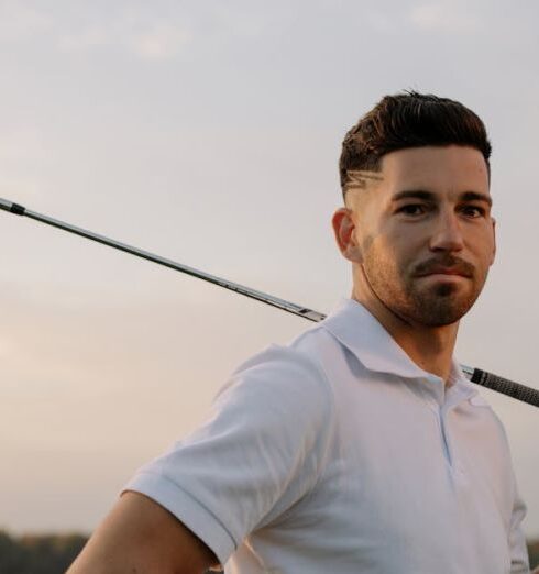 Tee - Man in White Polo Shirt Holding Black Fishing Rod