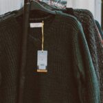 Sweaters - Assorted Clothes Hanging On A Rack Outside Store