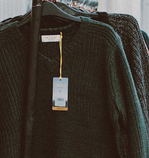 Sweaters - Assorted Clothes Hanging On A Rack Outside Store