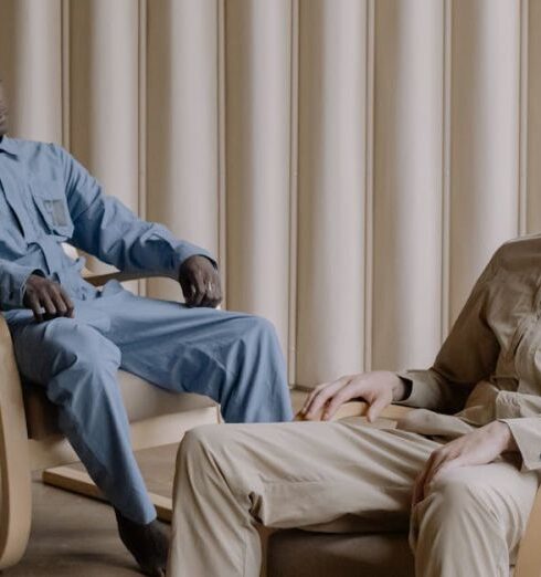 Jumpsuits - Men Sitting on Brown Chairs