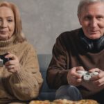 Sweaters - Man in Black Jacket Holding White Ceramic Mug Beside Woman in Brown Sweater