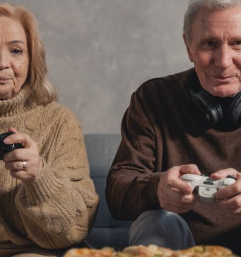 Sweaters - Man in Black Jacket Holding White Ceramic Mug Beside Woman in Brown Sweater