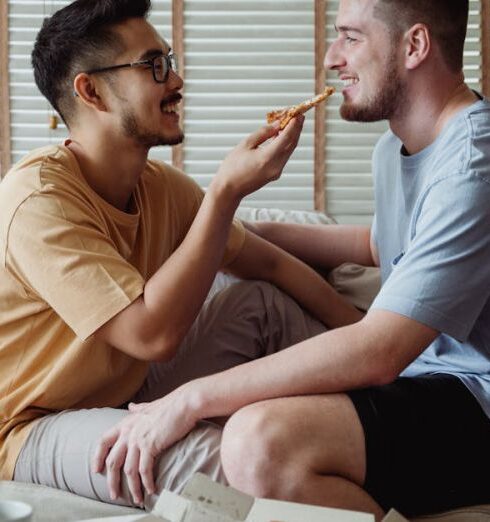 Eating - Man Feeding Pizza to Another Man