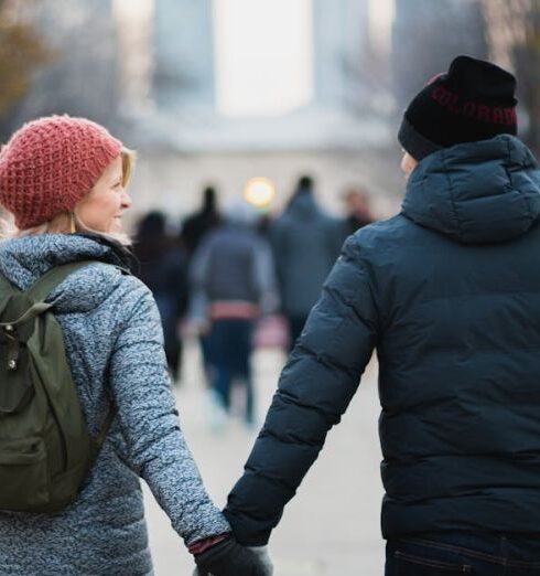 Jackets - Man and Woman Holding Hands While Walking at Park