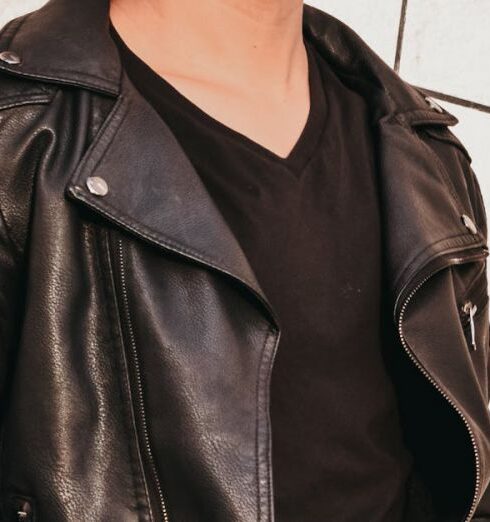 Jacket - Man in Black Leather Jacket Leaning on White Concrete Wall