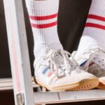 Shoes - Photograph of a Person Wearing White and Red Socks