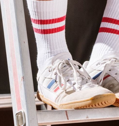 Shoes - Photograph of a Person Wearing White and Red Socks