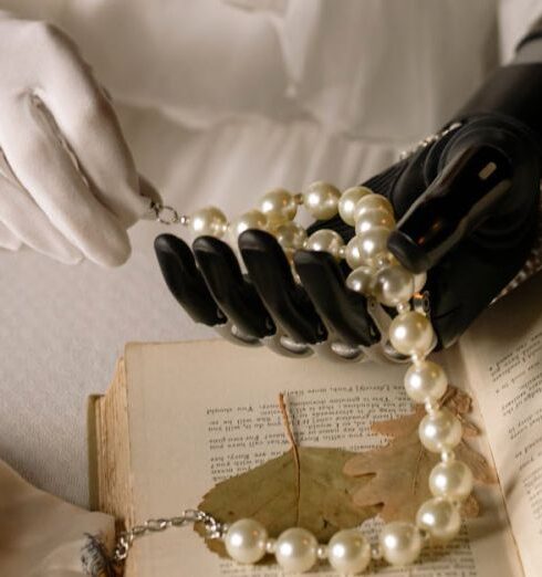 Clutch - Person Wearing Gold Ring and White Pearl Bracelet