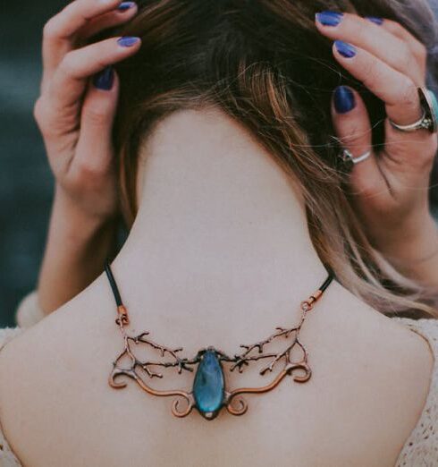 Necklace - Woman Wears Gold-colored Blue Gemstone Pendant Necklace