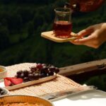 Meals - Woman Hands with Tea over Table with Breakfast