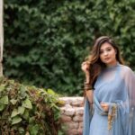 Dress - Woman in Blue Dress Standing Near Brown Concrete Bricks