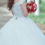 Gown - Woman in White Wedding Dress Holding Red Bouquet