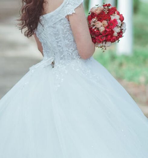 Gown - Woman in White Wedding Dress Holding Red Bouquet