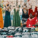 Dresses - Woman Seated Next to Assorted Dresses