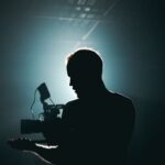 Set - Silhouette of Man Standing in Front of Microphone