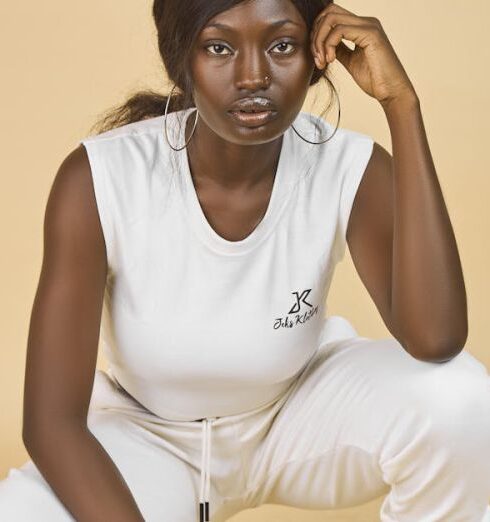 Joggers - A woman in white pants and sneakers squatting