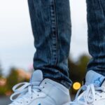 Sneakers - Person Wearing White And Blue Air Jordan 1's