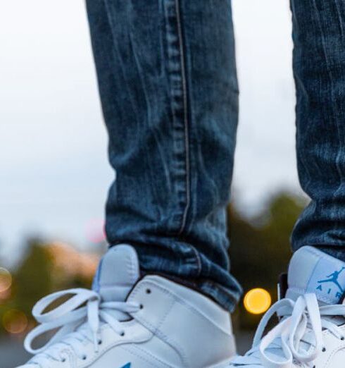 Sneakers - Person Wearing White And Blue Air Jordan 1's