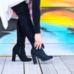 Boots - Photo of Woman Touching Right Heeled Shoe Beside Wall