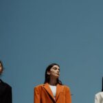 Blazers - A Group of Women Standing on the Rock while Wearing Blazers and Pants