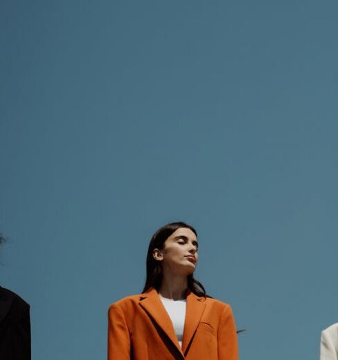 Blazers - A Group of Women Standing on the Rock while Wearing Blazers and Pants