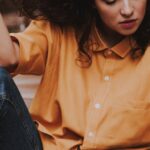 Blouse - Woman Sitting on Wooden Chair While Holding Her Hair