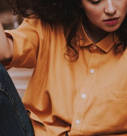 Blouse - Woman Sitting on Wooden Chair While Holding Her Hair