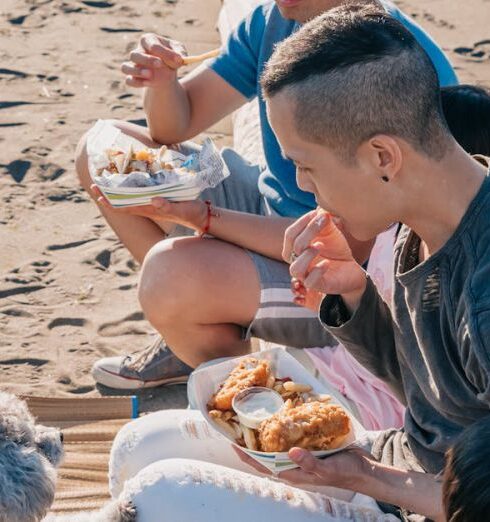 Snacks For Kids - Family Sitting on a Log while Eating Snacks