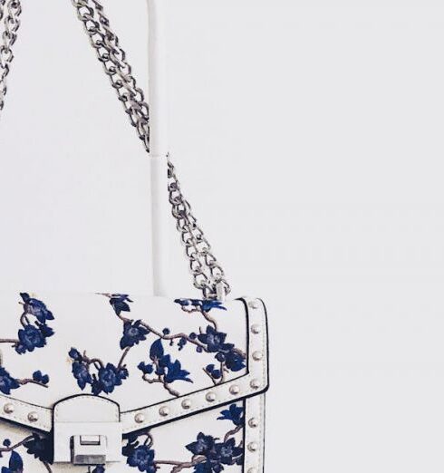 Handbags - White and Blue Floral Flap Sling Bag Hanging on White Steel Rack