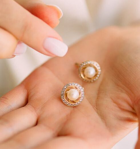 Earrings - Close-Up Photo of Person Holding Earrings