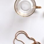 Necklace - Gold-colored Heart Pendant Necklace Beside Two Glass Mugs on Table