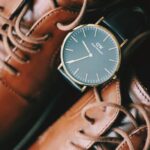 Belts - Close Up Photo of a Pair of Brown Shoes,Wrist Watch, Sunglasses,Belt and CK Spray