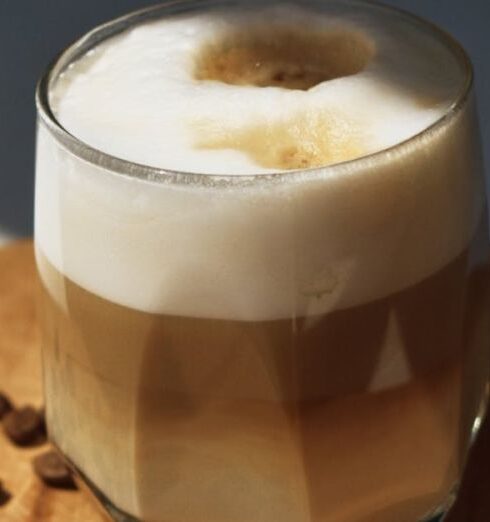 Beanies - A glass of coffee with beans on top